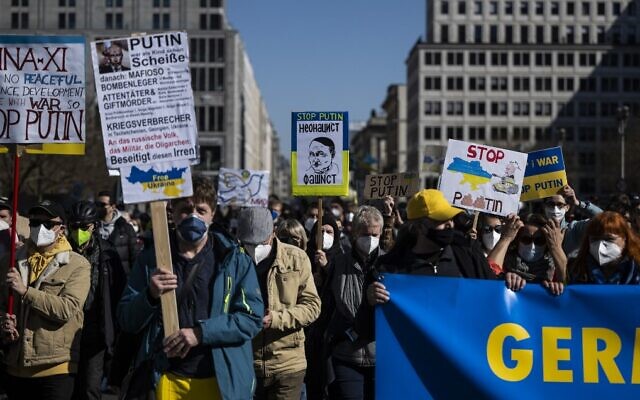 A protester displays a placard featuring a caricature of Russian President Vladimir Putin as Nazi German leader Adolf Hitler during a demonstration against Russia's invasion of the Ukraine, on March 13, 2022, in Berlin. (John MacDougall/AFP) A protester displays a placard featuring a caricature of Russian President Vladimir Putin as Nazi German leader Adolf Hitler during a demonstration against Russia's invasion of the Ukraine, on March 13, 2022, in Berlin. (John MacDougall/AFP)