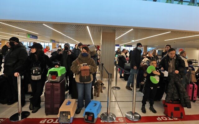 Ukrainian Jewish refugees, who fled the war in their country, wait at the check-in counters ahead of their flight to Tel Aviv in the Moldovan capital Chisinau on March 14, 2022. (GIL COHEN-MAGEN / AFP)