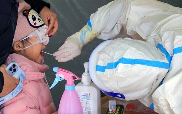 A child undergoes a nucleic acid test for the COVID-19 coronavirus in Yantai, in China's eastern Shandong province, March 14, 2022. (AFP photo / China OUT) A child undergoes a nucleic acid test for the COVID-19 coronavirus in Yantai, in China's eastern Shandong province, March 14, 2022. (AFP photo / China OUT)