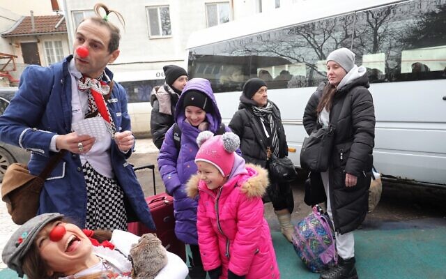 Volunteers with Jewish organization LeMa'anam dressed as clowns play with children as Ukrainian Jewish refugees who fled the war in their country wait to be flown to Israel in the coming days, on March 16, 2022 in the Moldova's capital Chisinau (GIL COHEN-MAGEN / AFP) Volunteers with Jewish organization LeMa'anam dressed as clowns play with children as Ukrainian Jewish refugees who fled the war in their country wait to be flown to Israel in the coming days, on March 16, 2022 in the Moldova's capital Chisinau (GIL COHEN-MAGEN / AFP)