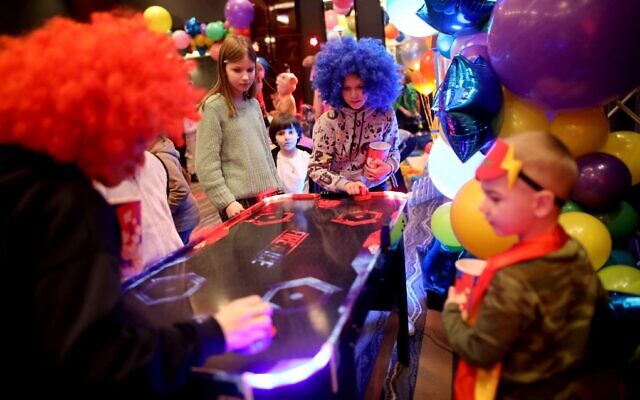 Illustrative: Ukrainian Jewish refugees who fled the Russian invasion celebrate the Jewish holiday of Purim at the Chabad-Lubavitch synagogue in Chisinau, Moldova, on March 16, 2022. (Gil Cohen-Magen/AFP)