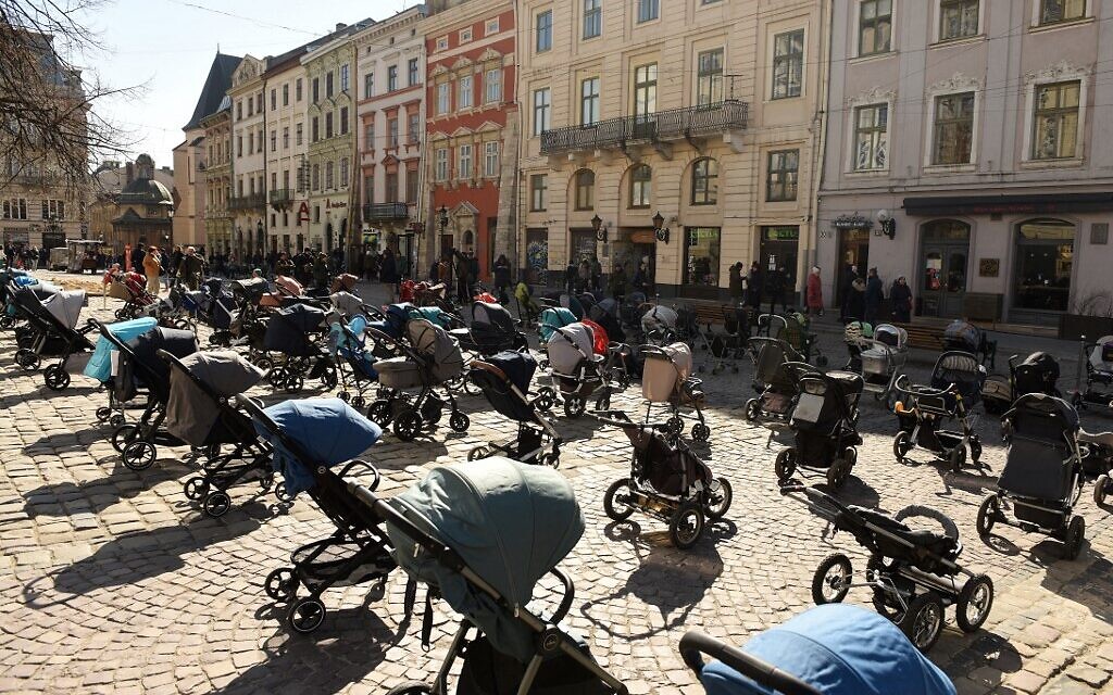 In this picture taken on March 18, 2022, 109 empty prams and baby baskets are seen placed outside the Lviv city council during an action to highlight the number of children killed in the ongoing Russian invasion of Ukraine. (Yuriy Dyachyshyn / AFP)