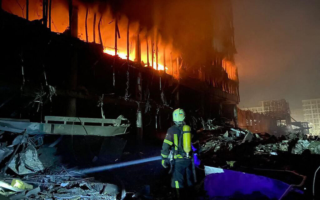 This handout picture taken and released by Ministry of Internal Affairs of Ukraine Press Service on March 21, 2022 shows  firefighters putting out a fire in shopping center following Russian shelling in Kyiv (Photo by Ministry of Internal Affairs of Ukraine Press Service / AFP)