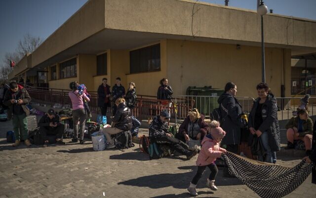 Ukrainian evacuees stand outside the train station in Przemysl, near the Polish-Ukrainian border, on March 22, 2022, following Russia's military invasion of Ukraine. (Angelos Tzortzinis/AFP) Ukrainian evacuees stand outside the train station in Przemysl, near the Polish-Ukrainian border, on March 22, 2022, following Russia's military invasion of Ukraine. (Angelos Tzortzinis/AFP)