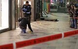 Israeli police cordon off the scene of a terror attack outside a shopping center in the southern city of Beersheba on March 22, 2022. (Ahmad Gharabli/AFP)