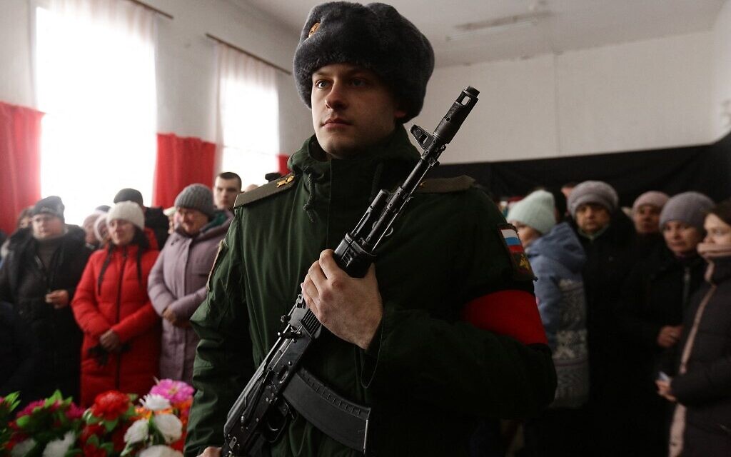 People attend a farewell ceremony for Sergei Sokolov, a 21 year-old Russian serviceman who was killed during Russian military action in Ukraine, in the settlement of Zubkovo in Novosibirsk region on March 24, 2022. ( Rostislav NETISOV / AFP)
