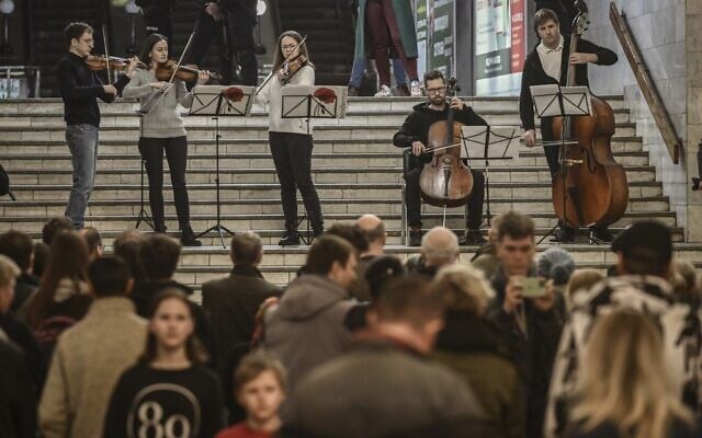 Musicians play for people living in a metro station used as a bomb shelter in Kharkiv, Ukraine, on March 26, 2022. (Aris Messinis/AFP) Musicians play for people living in a metro station used as a bomb shelter in Kharkiv, Ukraine, on March 26, 2022. (Aris Messinis/AFP)