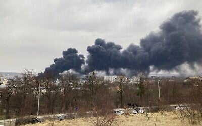 Smoke billows from the Pidzamche neighborhood after explosions were heard in the western Ukrainian city of Lviv, on March 26, 2022. (Marion Payet/AFP)
