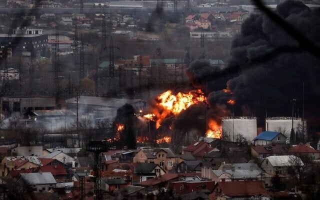 Dark smoke and flames rise from a fire following an air strike in the western Ukrainian city of Lviv, on March 26, 2022. (Ronaldo Chemidt and Ronaldo Schemidt/AFP) Dark smoke and flames rise from a fire following an air strike in the western Ukrainian city of Lviv, on March 26, 2022. (Ronaldo Chemidt and Ronaldo Schemidt/AFP)