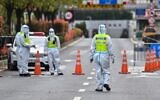 Police officers wearing protective gear control access to a tunnel in the direction of Pudong district in lockdown as a measure against the Covid-19 coronavirus, in Shanghai, March 28, 2022. (Hector RETAMAL / AFP)