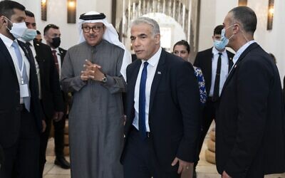 Foreign Minister Yair Lapid (C-R) walks alongside his Bahraini counterpart Abdullatif bin Rashid al-Zayani during the Negev summit in Sde Boker on March 28, 2022. (Jacquelyn MARTIN / POOL / AFP)