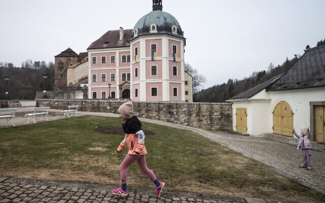 Ukrainian children play in a yard at the Becov nad Teplou castle complex, where Ukraininan refugees found a shelter, in Becov nad Teplou, Czech Republic, on March 29, 2022. (Michal Cizek / AFP)