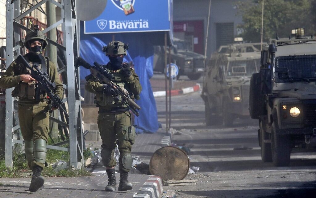 Israeli soldiers patrol a village near the northern West Bank city of Jenin on March 30, 2022, following a deadly terror attack in Bnei Brak. (AFP)