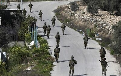 Israeli soldiers patrol on March 30, 2022 a village south of Jenin in the West Bank. (AFP) Israeli soldiers patrol on March 30, 2022 a village south of Jenin in the West Bank. (AFP)