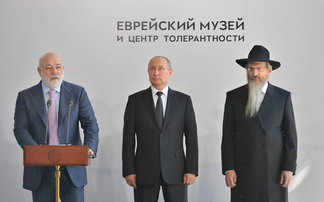 Russian President Vladimir Putin, center, and Russian Chief Rabbi Berel Lazar, right, listen to businessman Viktor Vekselberg speak at a ceremony outside the Jewish Museum of Moscow, Russia, on June 4, 2019. (Courtesy of the Jewish Museum and Tolerance Center of Moscow/via JTA)