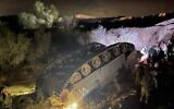 Soldiers inspect an IDF Namer APC that flipped over during an exercise in southern Israel on March 3, 2022. (Courtesy)
