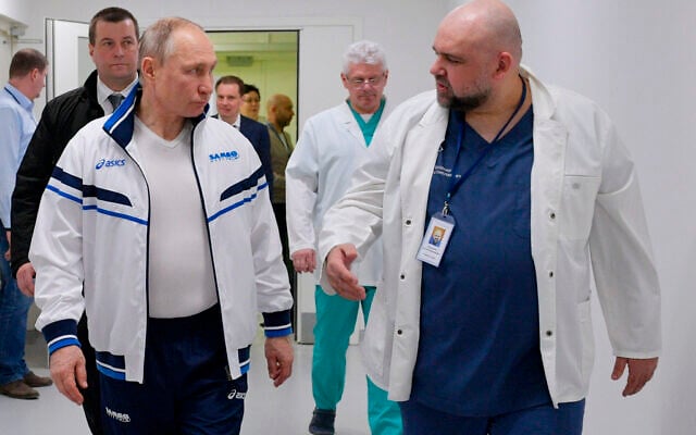 Illustrative: Russian President Vladimir Putin, center, and hospital chief Denis Protsenko, right, walk in the Kommunarka hospital on March 23, 2020. (Alexei Druzhinin, Sputnik, Kremlin Pool Photo via AP, File)