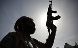 Illustrative: A silhouette of a Houthi supporter holds his weapon during a rally marking six years for a Saudi-led coalition in Sanaa, Yemen, on Friday, March 26, 2021. (AP Photo/Hani Mohammed)