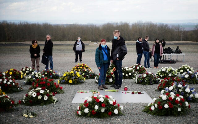 People stand between wreaths after a wreath laying ceremony marking the 76th anniversary of the liberation of the Nazi concentration camp Buchenwald near Weimar, Germany, April 11, 2021. (Markus Schreiber/AP) People stand between wreaths after a wreath laying ceremony marking the 76th anniversary of the liberation of the Nazi concentration camp Buchenwald near Weimar, Germany, April 11, 2021. (Markus Schreiber/AP)