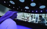 A Journalist watches a show of the Israeli pavilion during a media tour at the Dubai Expo in Dubai, United Arab Emirates, Sept. 27, 2021 (AP Photo/Kamran Jebreili)