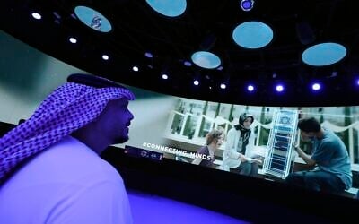 A Journalist watches a show of the Israeli pavilion during a media tour at the Dubai Expo in Dubai, United Arab Emirates, Sept. 27, 2021 (AP Photo/Kamran Jebreili)
