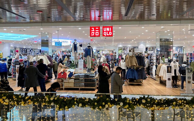 People shop at a Uniqlo retail clothing store in the Hudson Yards shopping mall in New York City on December 4, 2021. (AP Photo/Ted Shaffrey)