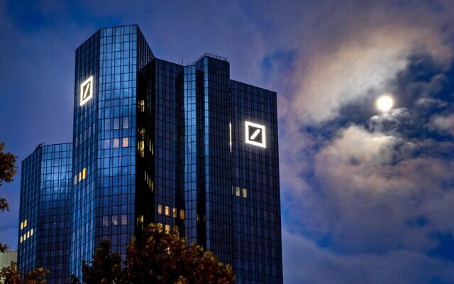 FILE — The moon shines next to the headquarters of the Deutsche Bank in Frankfurt, Germany, October 4, 2020.  (AP Photo/Michael Probst, File)