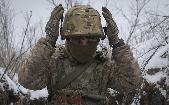 Illustrative: A Ukrainian serviceman adjusts his helmet while working to fix a trench that was damaged by a mortar strike at a front line position, less than 100 meters from Russian separatists positions, in the Luhansk area, eastern Ukraine, January 28, 2022. (AP Photo/Vadim Ghirda) Illustrative: A Ukrainian serviceman adjusts his helmet while working to fix a trench that was damaged by a mortar strike at a front line position, less than 100 meters from Russian separatists positions, in the Luhansk area, eastern Ukraine, January 28, 2022. (AP Photo/Vadim Ghirda)