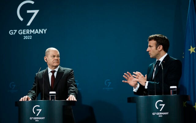German Chancellor Olaf Scholz, left, listens to French President Emmanuel Macron during a joint press conference in Berlin, February 8, 2022. (AP Photo/Thibault Camus, Pool)