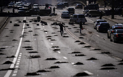Cars are stopped at a roadblock set by civil defensemen at a road leading to central Kyiv, Ukraine, Monday, Feb. 28, 2022. (AP/Emilio Morenatti)