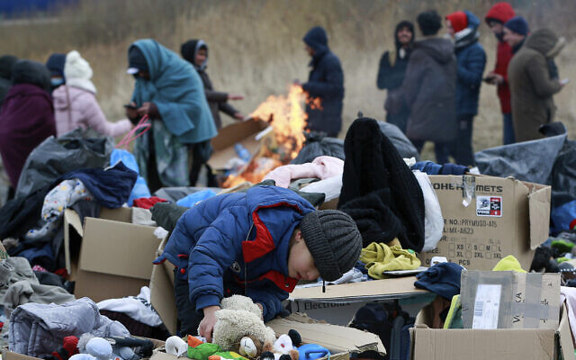 A child collects toys near a clothes donation point as refugees fleeing conflict in Ukraine arrive at the Medyka border crossing in Poland, on February 28, 2022. (AP Photo/Visar Kryeziu) A child collects toys near a clothes donation point as refugees fleeing conflict in Ukraine arrive at the Medyka border crossing in Poland, on February 28, 2022. (AP Photo/Visar Kryeziu)