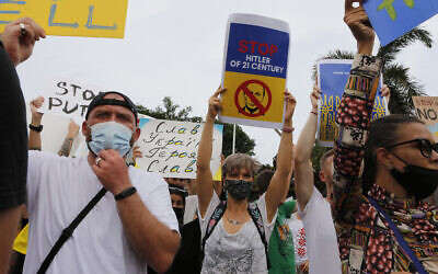 A group of Ukrainian people in Bali and supporters hold posters to protest against the invasion of Russia in front of the Ukraine consulate office in Denpasar, Bali, Indonesia on March 1, 2022. (AP Photo/Firdia Lisnawati)