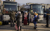 Ukrainians prepare to board a bus to Poland at Lviv bus main station, western Ukraine, March 1, 2022 (AP Photo/Bernat Armangue)