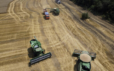 Farmers harvest with their combines in a wheat field near the village Tbilisskaya, Russia, July 21, 2021. (AP Photo/Vitaly Timkiv, File)