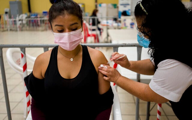 A healthcare worker administers an AstraZeneca booster shot for COVID-19 at a vaccination center in Guatemala City, March 1, 2022. (AP Photo/Moises Castillo) A healthcare worker administers an AstraZeneca booster shot for COVID-19 at a vaccination center in Guatemala City, March 1, 2022. (AP Photo/Moises Castillo)