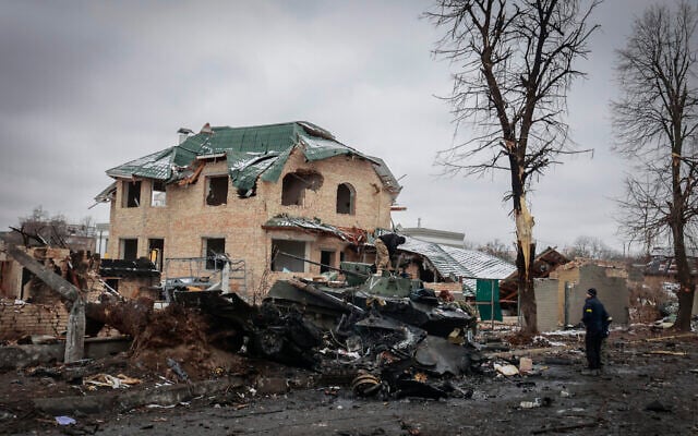 A man looks at the gutted remains of Russian military vehicles on a road in the town of Bucha, close to the capital Kyiv, Ukraine, March 1, 2022. (AP Photo/Serhii Nuzhnenko) A man looks at the gutted remains of Russian military vehicles on a road in the town of Bucha, close to the capital Kyiv, Ukraine, March 1, 2022. (AP Photo/Serhii Nuzhnenko)