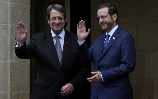 Cyprus' president Nicos Anastasiades, left, and Israeli President Isaac Herzog wave to the media before their meeting at the presidential palace in Nicosia, Cyprus, March 2, 2022. (AP Photo/Petros Karadjias) Cyprus' president Nicos Anastasiades, left, and Israeli President Isaac Herzog wave to the media before their meeting at the presidential palace in Nicosia, Cyprus, March 2, 2022. (AP Photo/Petros Karadjias)