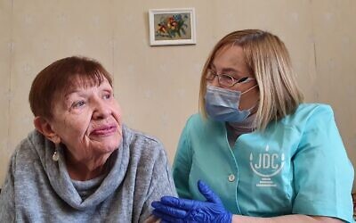 Natalia Berezhnaya, left, is seen in Odesa, Ukraine, in this undated photo with her home care worker. (Alexander Vdovichenko/The Jewish Joint Distribution Committee via AP)