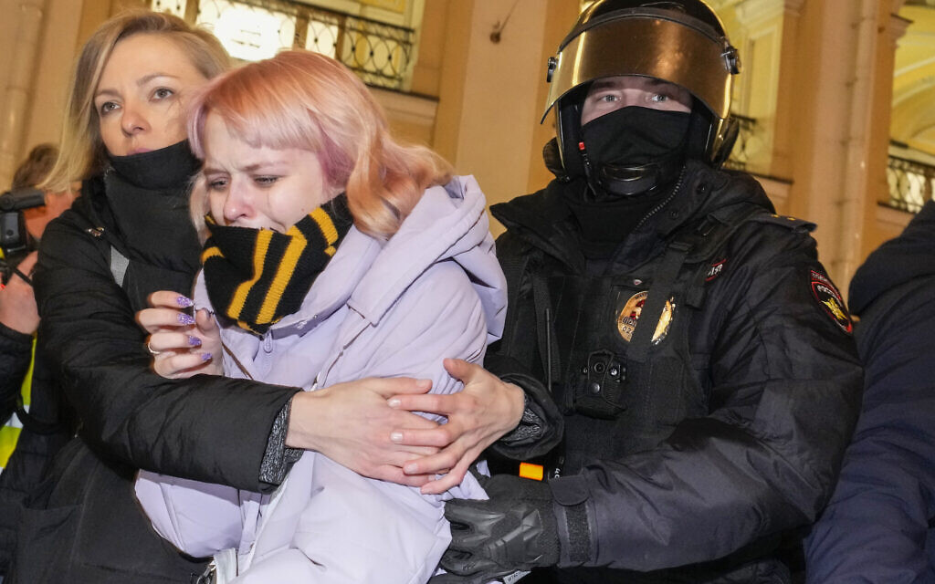 A Russian police officer, right, detains a demonstrator during a demonstration against Russia's attack on Ukraine in St. Petersburg, Russia, March 2, 2022. (AP Photo/Dmitri Lovetsky)
