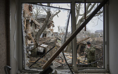 Andrey Goncharuk, 68, a member of territorial defense, wipes his face in the backyard of a house that was damaged by a Russian airstrike, according to locals, in Gorenka, outside the capital Kyiv, Ukraine, March 2, 2022. (AP Photo/Vadim Ghirda) Andrey Goncharuk, 68, a member of territorial defense, wipes his face in the backyard of a house that was damaged by a Russian airstrike, according to locals, in Gorenka, outside the capital Kyiv, Ukraine, March 2, 2022. (AP Photo/Vadim Ghirda)