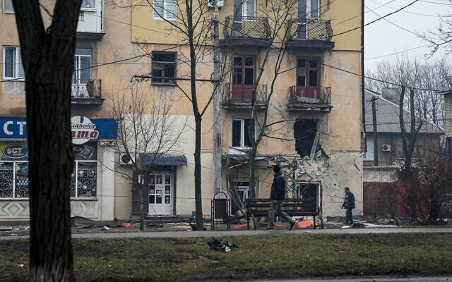 A man walks past an apartment building hit by shelling in Mariupol, Ukraine, on March 2, 2022. (AP Photo/Evgeniy Maloletka) A man walks past an apartment building hit by shelling in Mariupol, Ukraine, on March 2, 2022. (AP Photo/Evgeniy Maloletka)