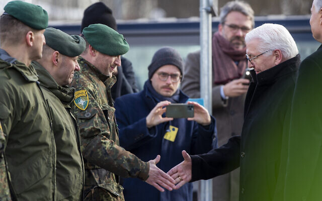 German President Frank-Walter Steinmeier, right, greets Lieutenant Colonel Daniel Andra, the commander of the multi-national NATO Enhanced Forward Presence battalion in Lithuania during a visit to the Rukla military base some 100 km (62.12 miles) west of the capital Vilnius, Lithuania, on March 3, 2022. (AP Photo/Mindaugas Kulbis) German President Frank-Walter Steinmeier, right, greets Lieutenant Colonel Daniel Andra, the commander of the multi-national NATO Enhanced Forward Presence battalion in Lithuania during a visit to the Rukla military base some 100 km (62.12 miles) west of the capital Vilnius, Lithuania, on March 3, 2022. (AP Photo/Mindaugas Kulbis)