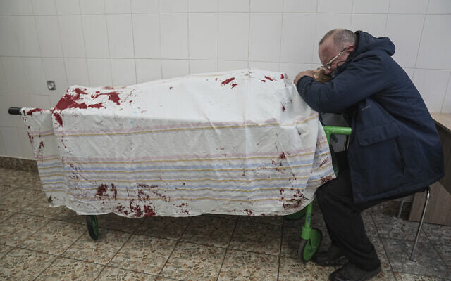 Serhii, father of teenager Iliya, cries on his son's lifeless body lying on a stretcher at a maternity hospital converted into a medical ward in Mariupol, Ukraine, on March 2, 2022. (AP/Evgeniy Maloletka) Serhii, father of teenager Iliya, cries on his son's lifeless body lying on a stretcher at a maternity hospital converted into a medical ward in Mariupol, Ukraine, on March 2, 2022. (AP/Evgeniy Maloletka)