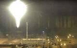 This image made from a video released by Zaporizhzhia nuclear power plant shows a bright flaring object landing in the grounds of the nuclear plant in Enerhodar, Ukraine, on March 4, 2022. (Zaporizhzhia nuclear power plant via AP)