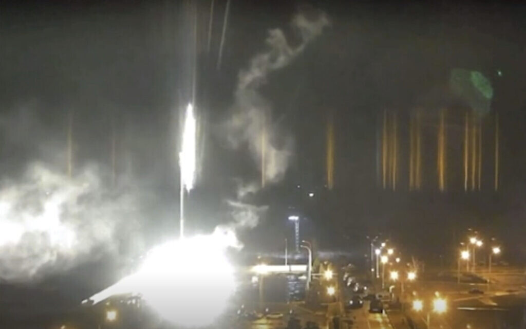 This image made from a video released by Zaporizhzhia nuclear power plant shows bright flaring object landing in grounds of the nuclear plant in Enerhodar, Ukraine, March 4, 2022. (Zaporizhzhia nuclear power plant via AP)
