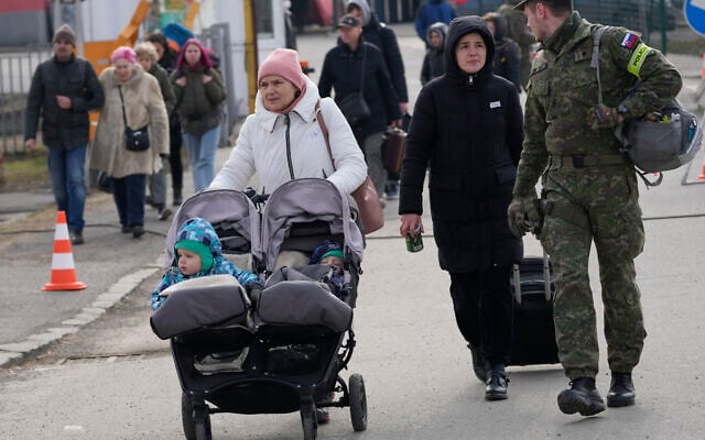 People fleeing from Ukraine cross the border in Vysne Nemecke, Slovakia, March 4, 2022. (Darko Vojinovic/AP)