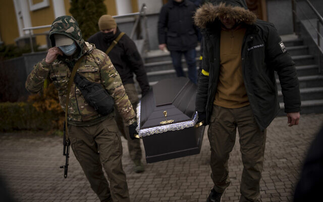 Militia men carry the coffin with the body of Volodymyr Nezhenets, 54, during his funeral in the city of Kyiv, Ukraine, March 4, 2022. (AP Photo/Emilio Morenatti) Militia men carry the coffin with the body of Volodymyr Nezhenets, 54, during his funeral in the city of Kyiv, Ukraine, March 4, 2022. (AP Photo/Emilio Morenatti)
