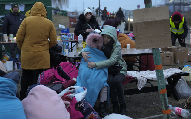 A mother embraces her daughter as they rest at the border crossing in Medyka, Poland, March 5, 2022, after fleeing the Ukraine. (AP Photo/Markus Schreiber) A mother embraces her daughter as they rest at the border crossing in Medyka, Poland, March 5, 2022, after fleeing the Ukraine. (AP Photo/Markus Schreiber)