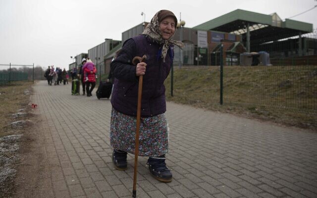An old woman holds on to a walking stick as refugees, mostly women with children, arrive at the border crossing in Medyka, Poland, March 5, 2022, after fleeing Russian invasion in Ukraine. (AP Photo/Visar Kryeziu) An old woman holds on to a walking stick as refugees, mostly women with children, arrive at the border crossing in Medyka, Poland, March 5, 2022, after fleeing Russian invasion in Ukraine. (AP Photo/Visar Kryeziu)