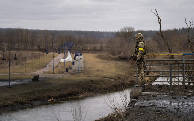 A Ukrainian soldier stands guard near a destroyed bridge at the Irpin river in the outskirts of Kyiv, Ukraine, March 5, 2022. (AP Photo/Emilio Morenatti) A Ukrainian soldier stands guard near a destroyed bridge at the Irpin river in the outskirts of Kyiv, Ukraine, March 5, 2022. (AP Photo/Emilio Morenatti)